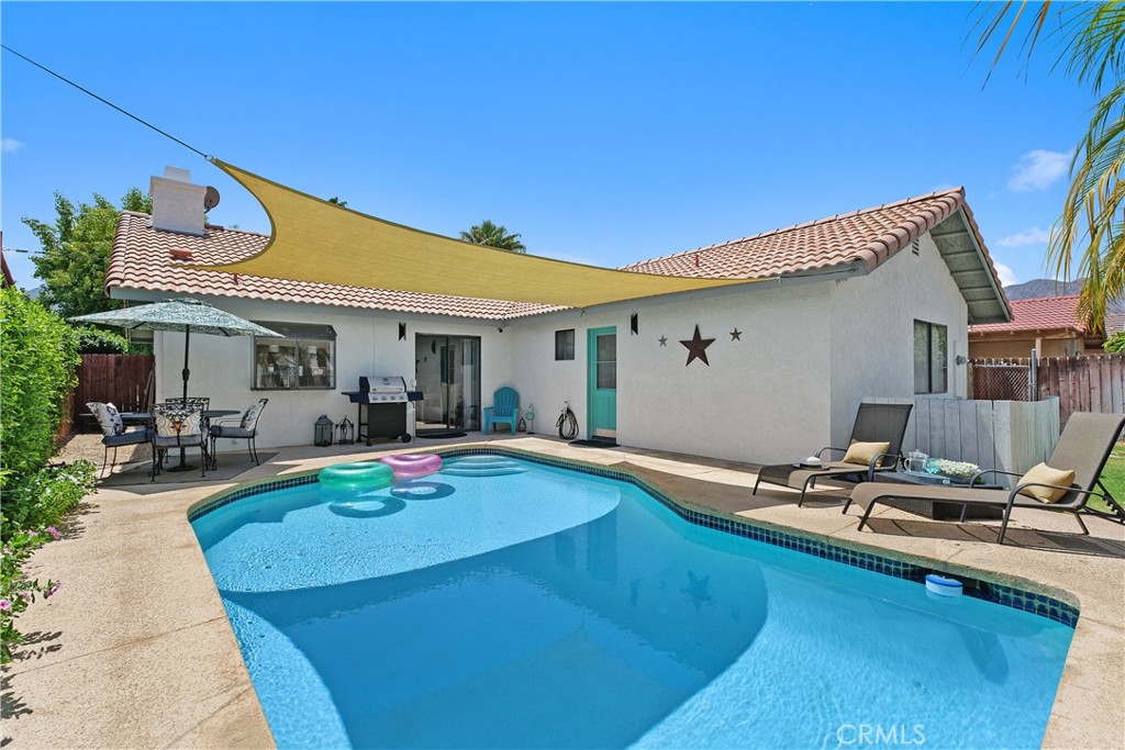 78680 Saguaro Road La Quinta, CA 92253 - Photo 2 of 30 a view of a house with backyard sitting area and swimming pool