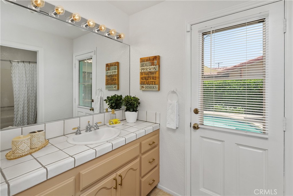 78680 Saguaro Road La Quinta, CA 92253 - Photo 22 of 30 a bathroom with a sink and a mirror