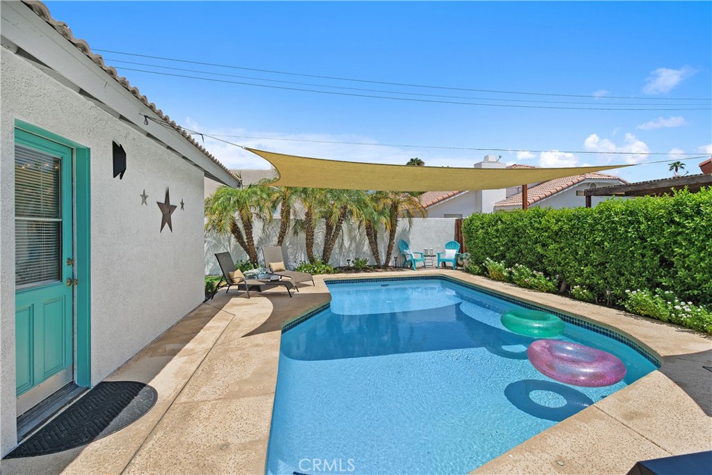 78680 Saguaro Road La Quinta, CA 92253 - Photo 25 of 30 a view of swimming pool with outdoor seating and plants