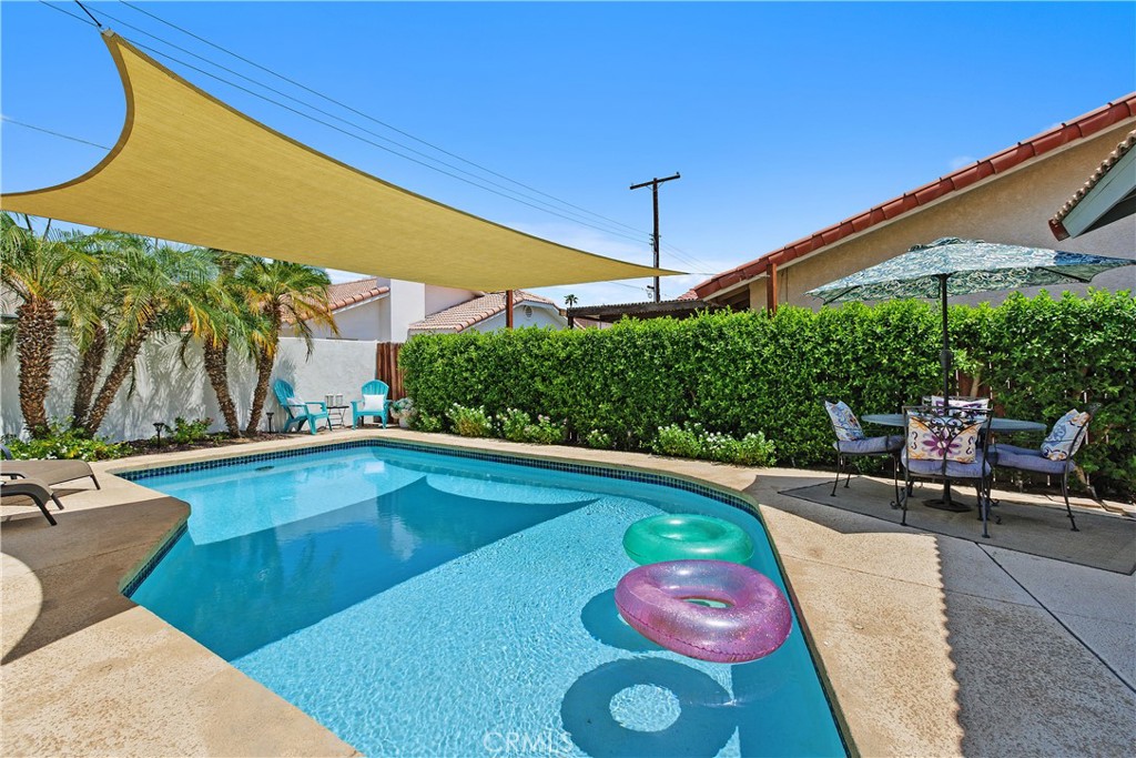 78680 Saguaro Road La Quinta, CA 92253 - Photo 26 of 30 a view of a swimming pool with a patio
