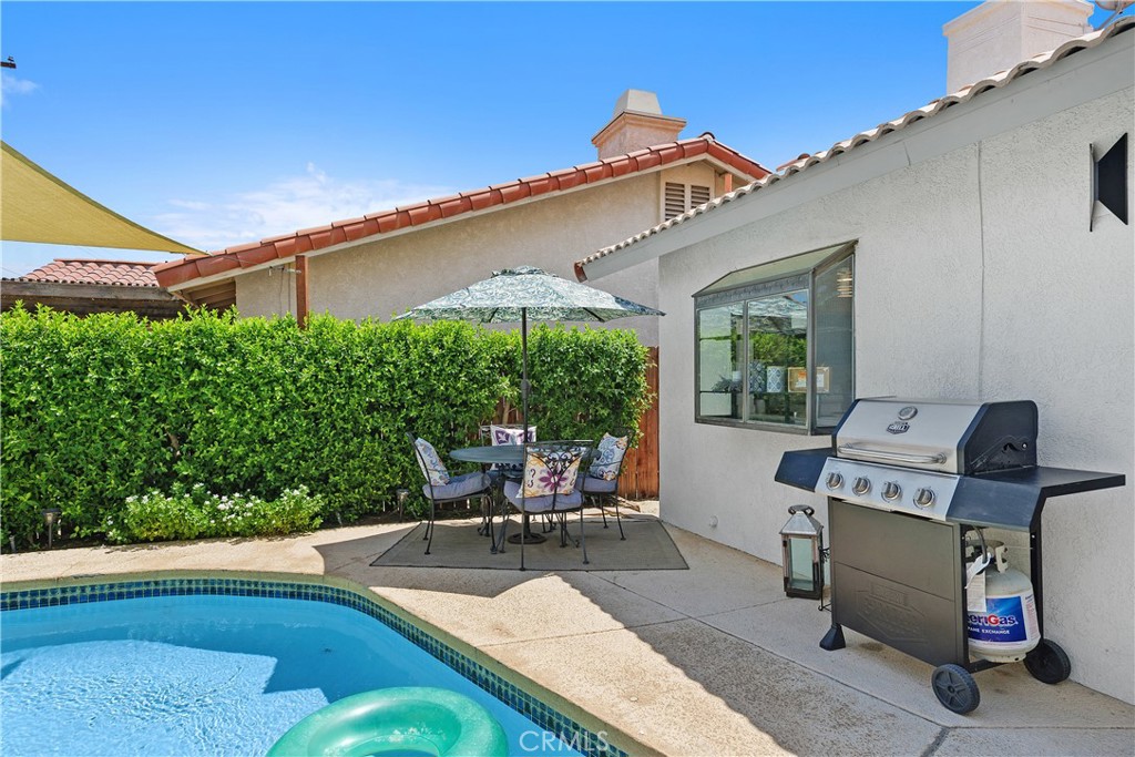 78680 Saguaro Road La Quinta, CA 92253 - Photo 27 of 30 a view of a patio with table and chairs under an umbrella