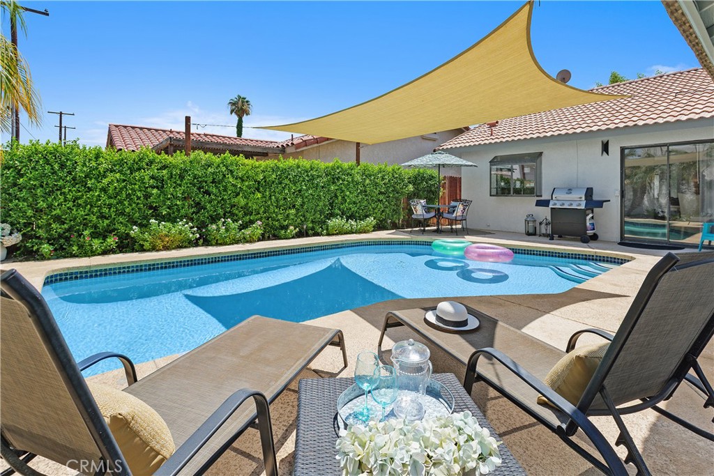 78680 Saguaro Road La Quinta, CA 92253 - Photo 30 of 30 a view of a patio with table and chairs under an umbrella