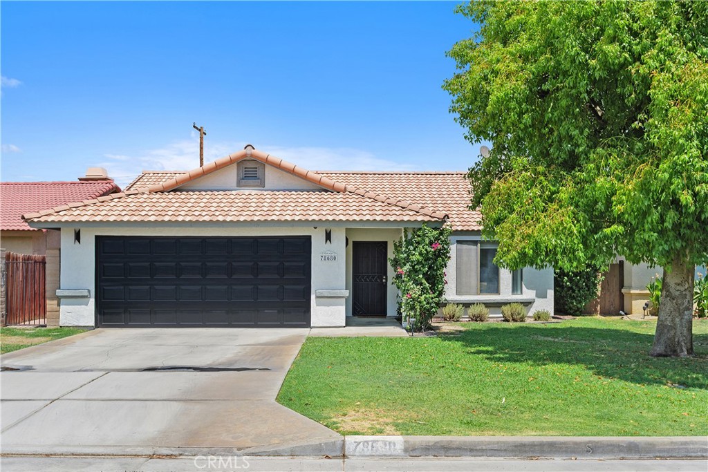 78680 Saguaro Road La Quinta, CA 92253 - Photo 3 of 30 a front view of a house with a garden