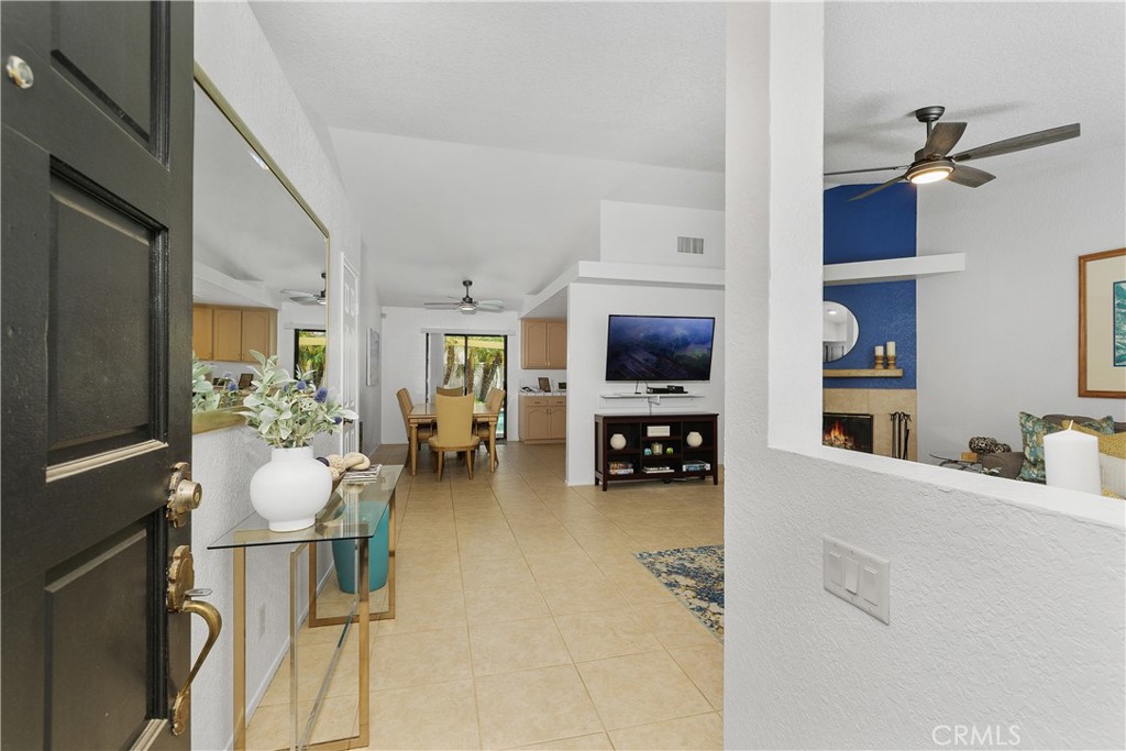78680 Saguaro Road La Quinta, CA 92253 - Photo 4 of 30 a living room with furniture and a flat screen tv