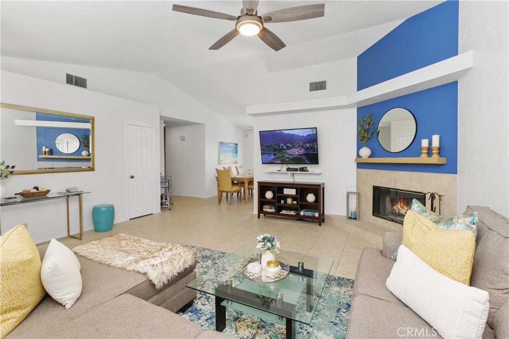 78680 Saguaro Road La Quinta, CA 92253 - Photo 7 of 30 a living room with furniture and a fireplace