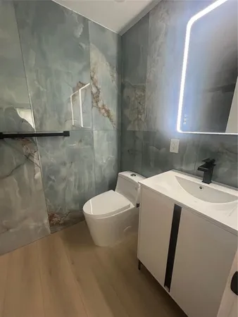 a white toilet sitting next to a bath tub and sink