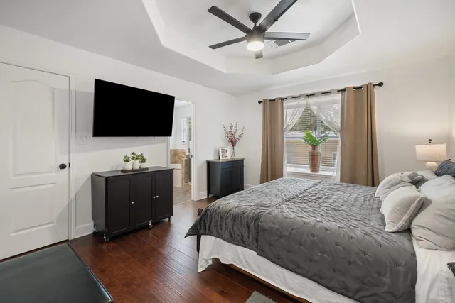 a bedroom with a bed and a flat screen tv