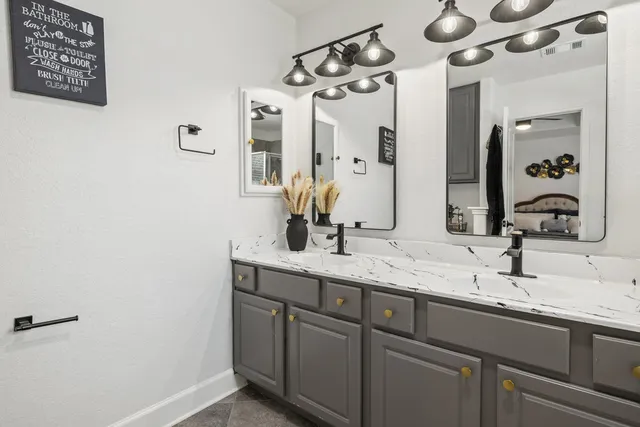 a bathroom with a double vanity sink and a mirror