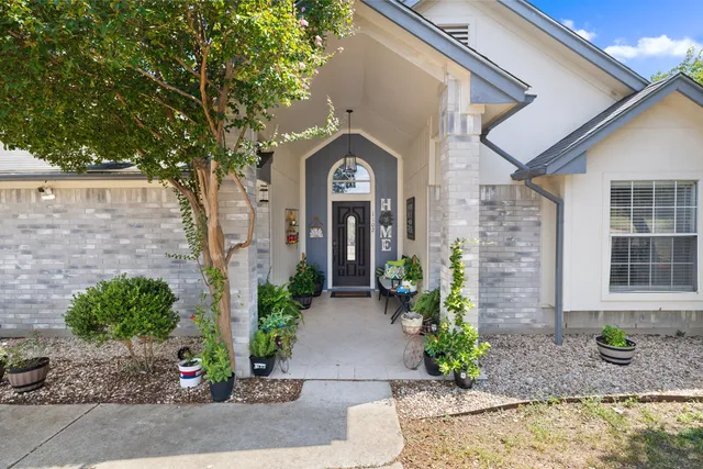 a front view of a house with garden