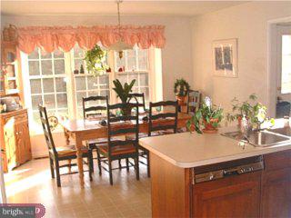 582 Sentinel Road Moorestown, NJ 08057 - Photo 3 of 6 a kitchen with a table chairs and a view of living room