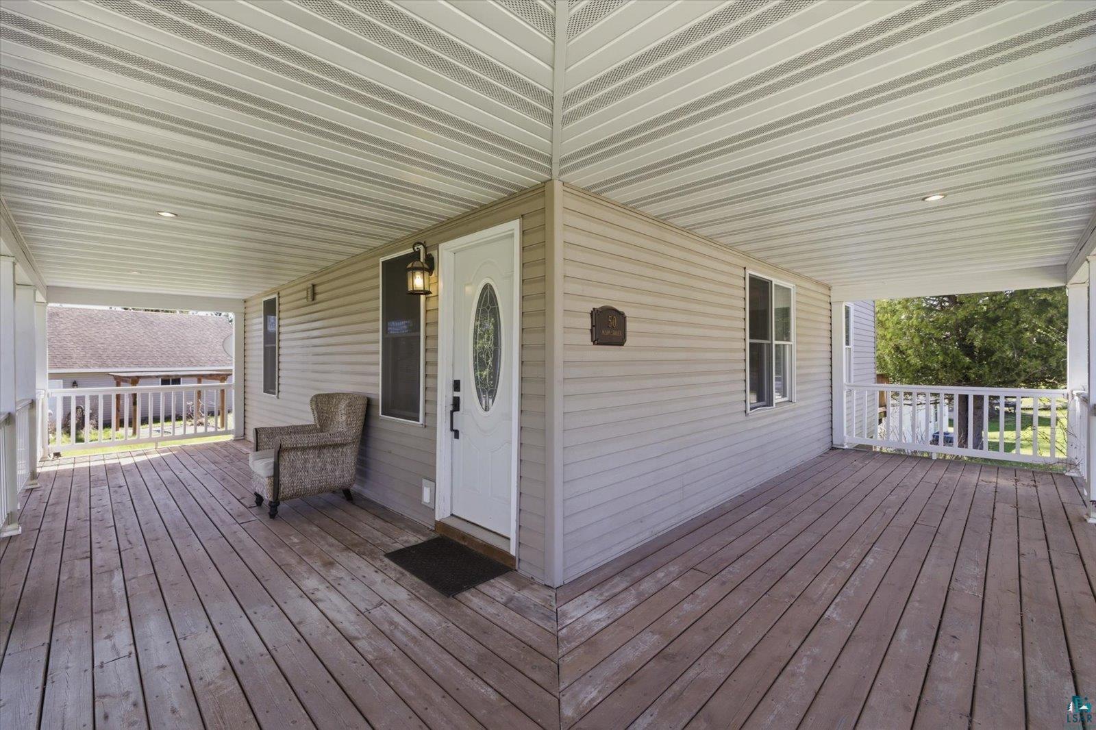 50 Main Street Soudan, MN 55782 - Photo 11 of 31 Spacious covered porch with wood flooring and white railing