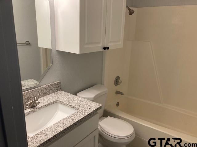 320 Blake Drive Longview, TX 75604 - Photo 7 of 9 a bathroom with a granite countertop sink toilet and shower