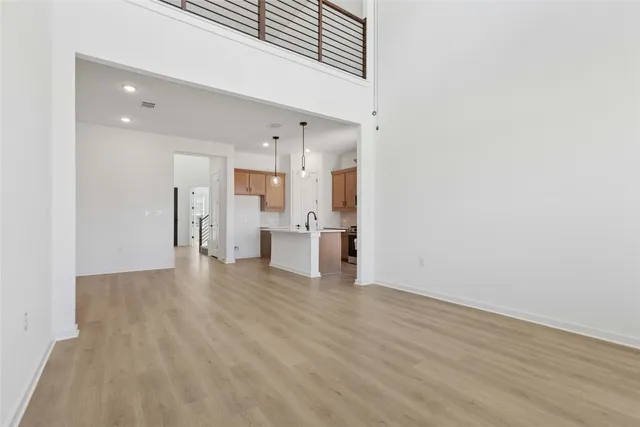 a view of a kitchen with a sink and a refrigerator