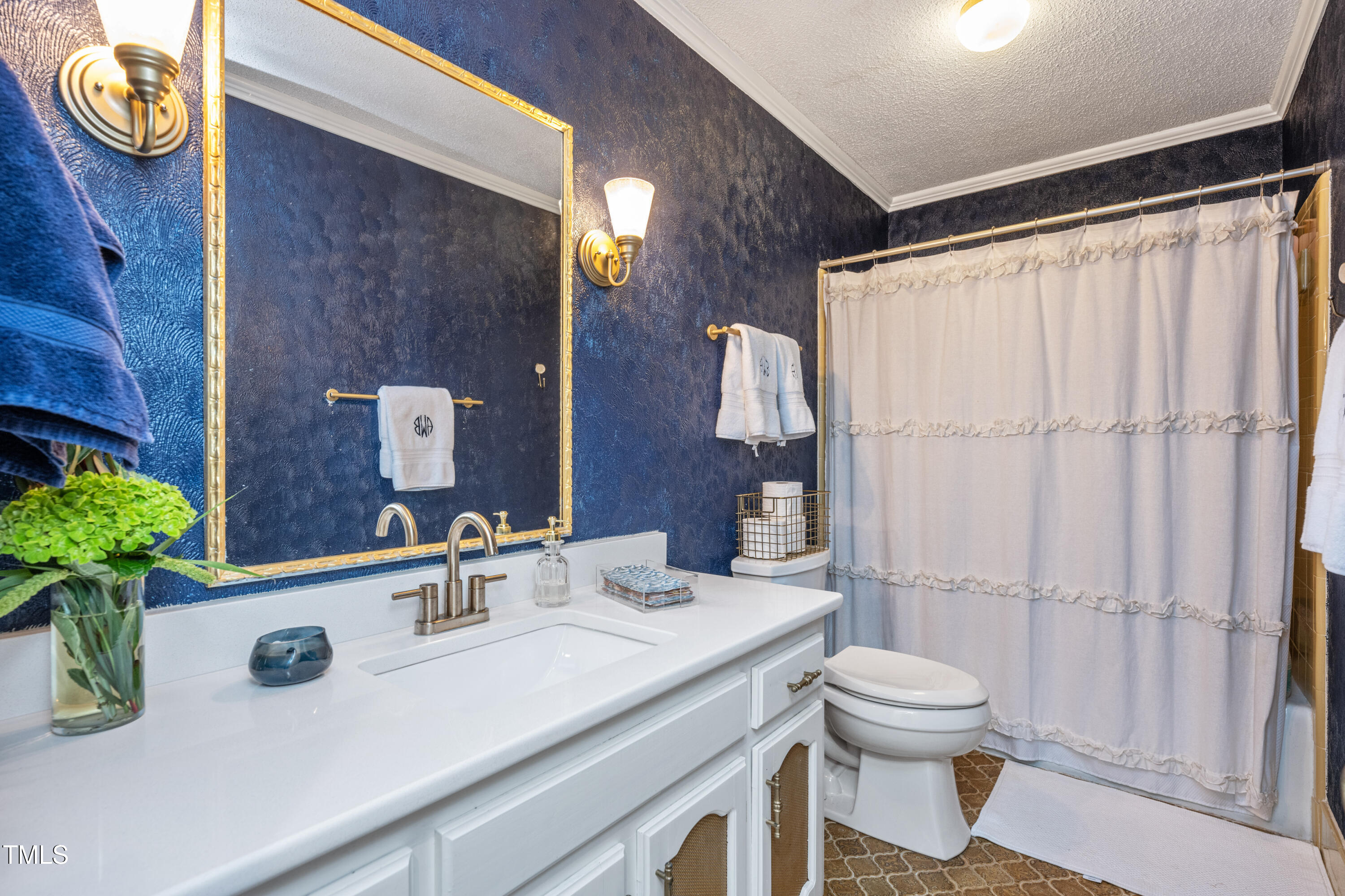 724 Hunting Ridge Road Raleigh, NC 27615 - Photo 16 of 24 a bathroom with a sink a toilet and shower