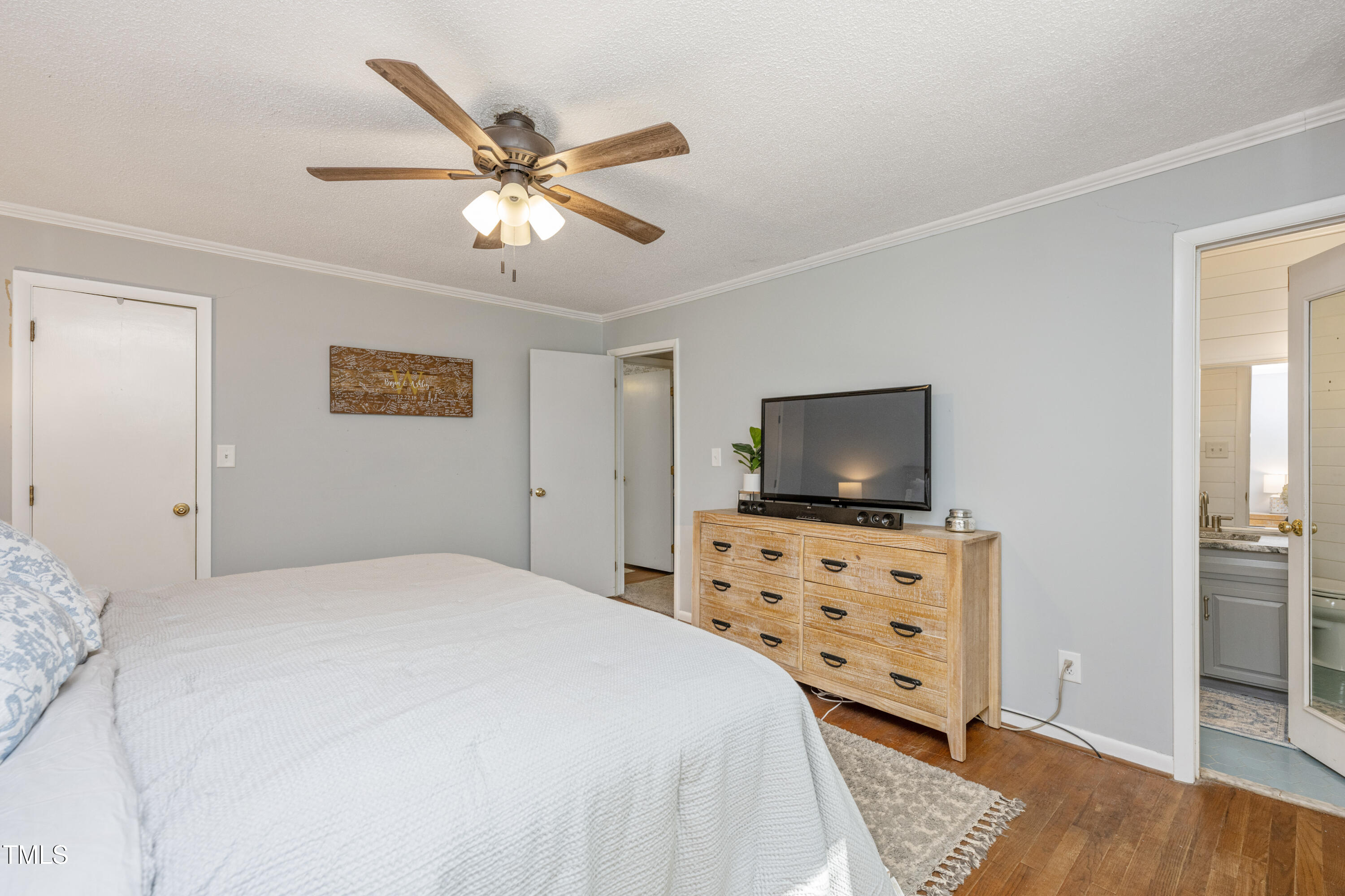 724 Hunting Ridge Road Raleigh, NC 27615 - Photo 18 of 24 a bedroom with a bed and a flat screen tv