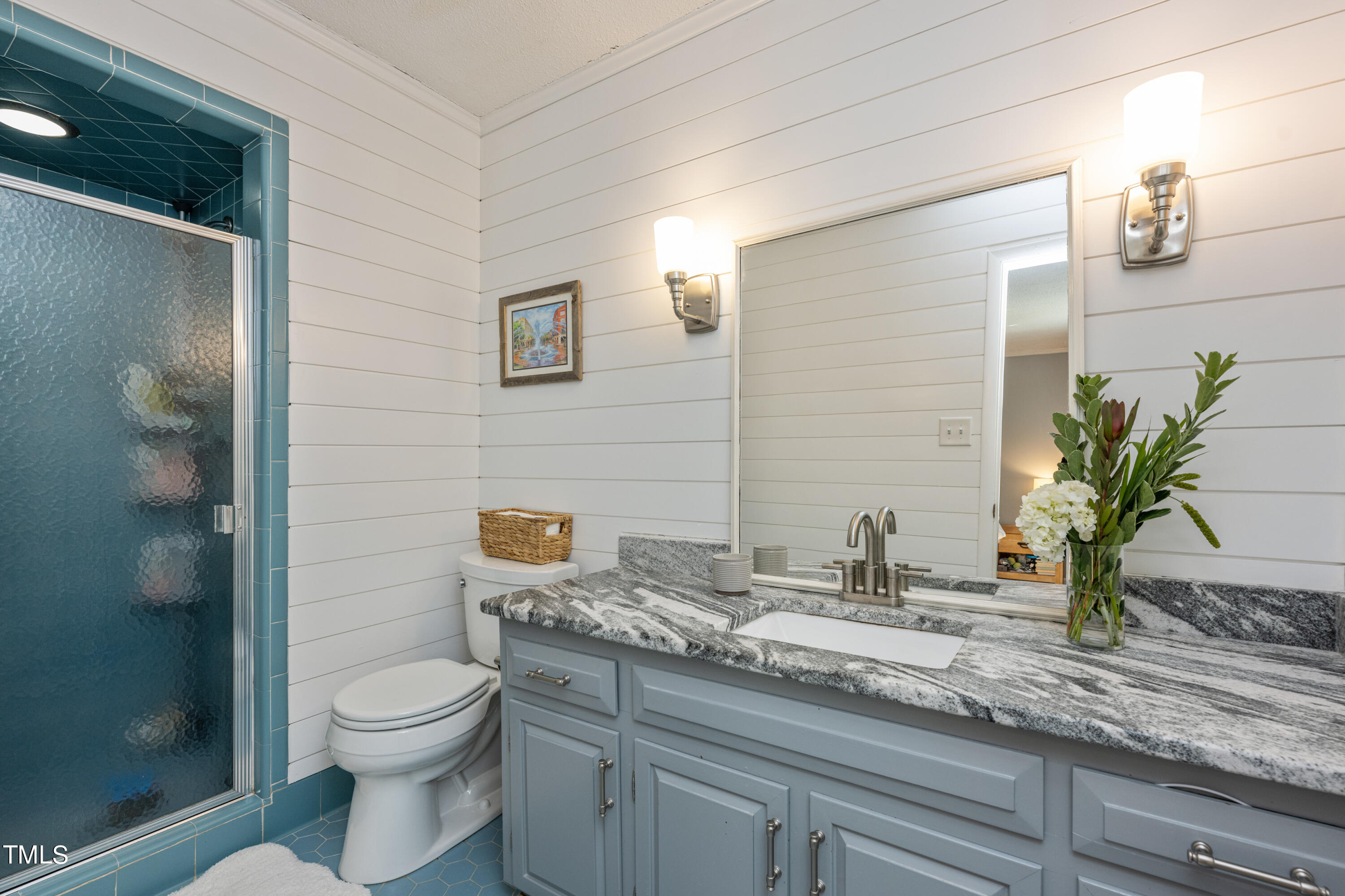 724 Hunting Ridge Road Raleigh, NC 27615 - Photo 19 of 24 a bathroom with a granite countertop sink a toilet and mirror