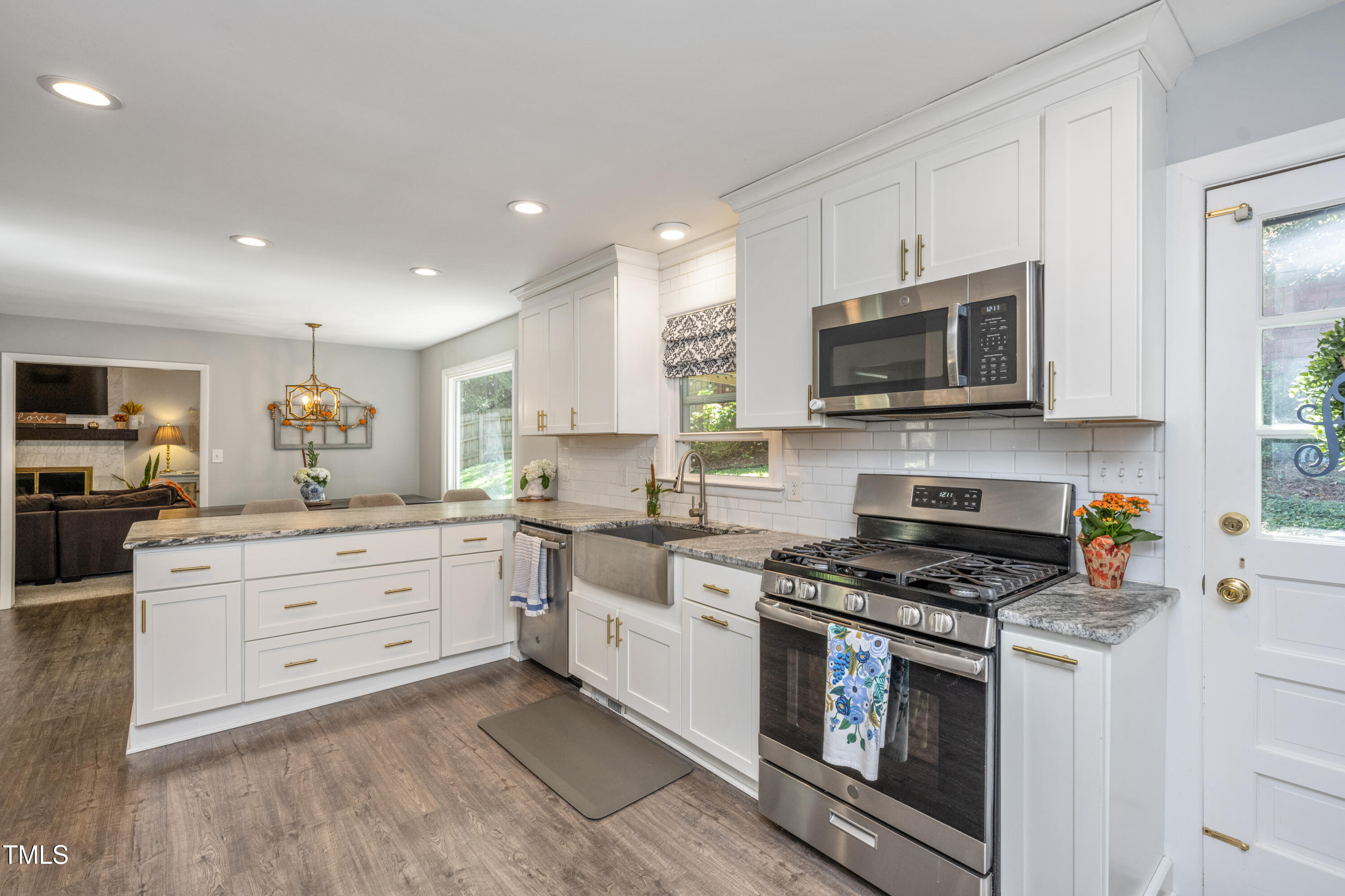 724 Hunting Ridge Road Raleigh, NC 27615 - Photo 20 of 24 a kitchen with stainless steel appliances granite countertop a stove a sink and a microwave