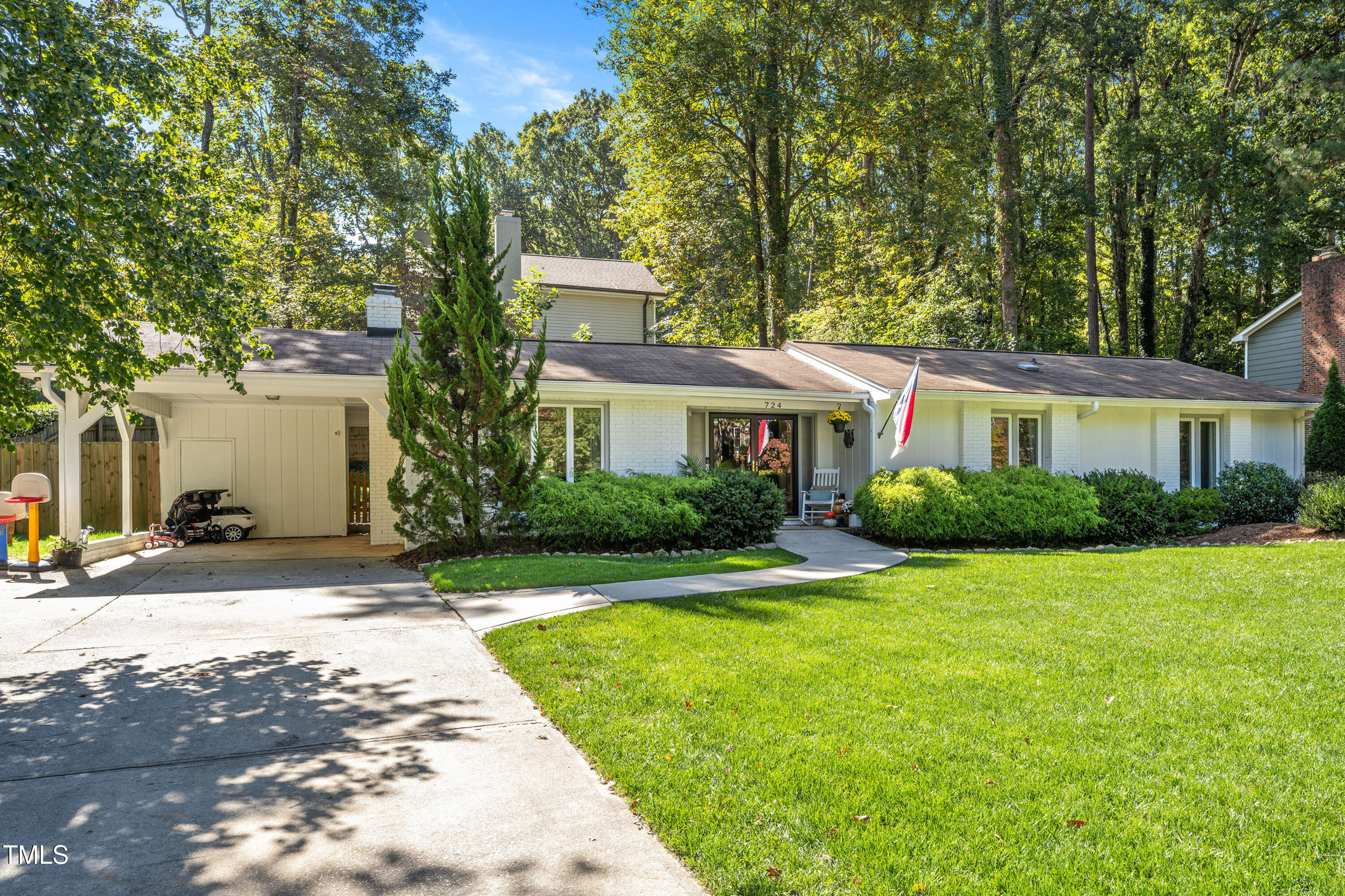 724 Hunting Ridge Road Raleigh, NC 27615 - Photo 2 of 24 a front view of a house with a yard and garage