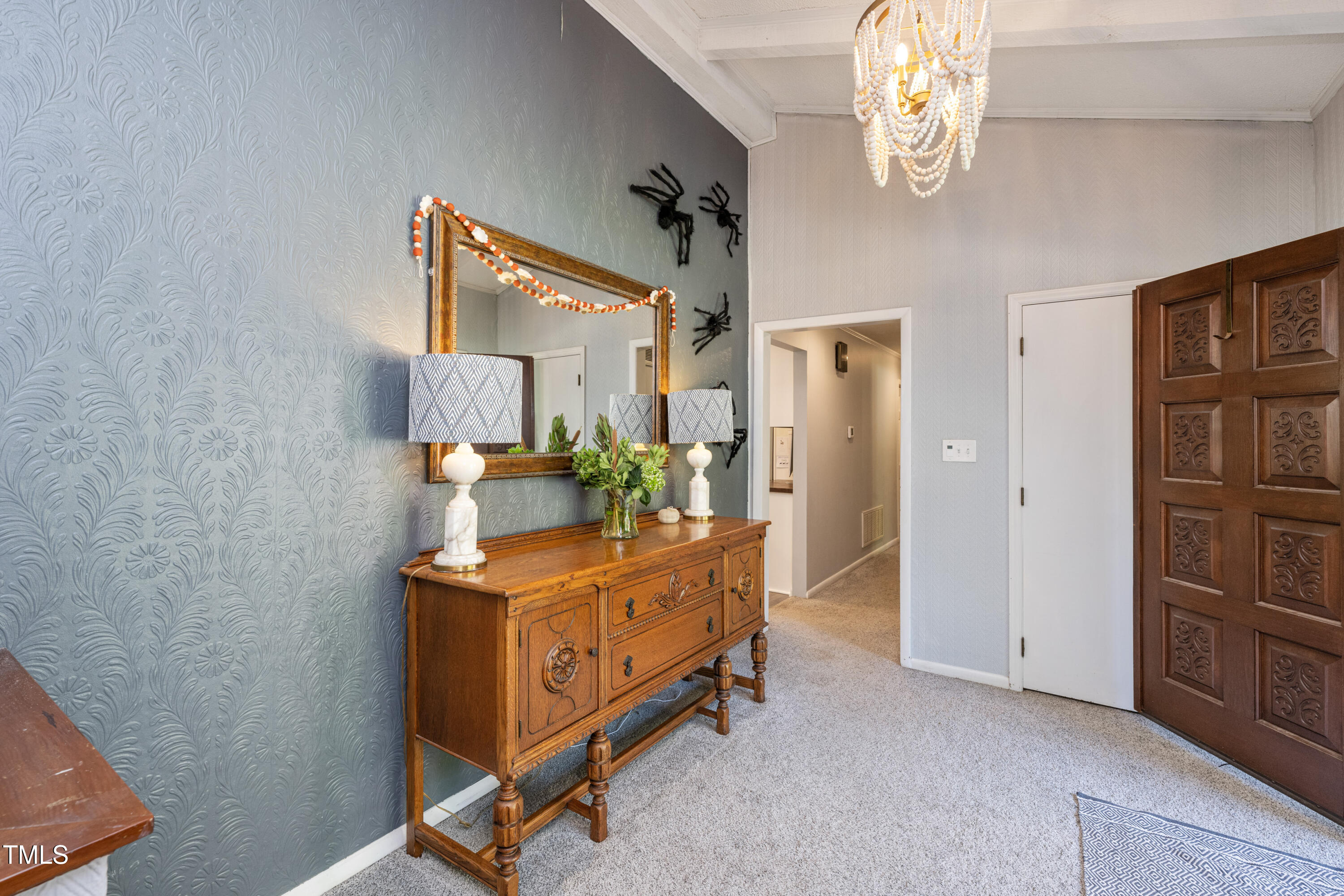 724 Hunting Ridge Road Raleigh, NC 27615 - Photo 4 of 24 a room with a bed and a chandelier