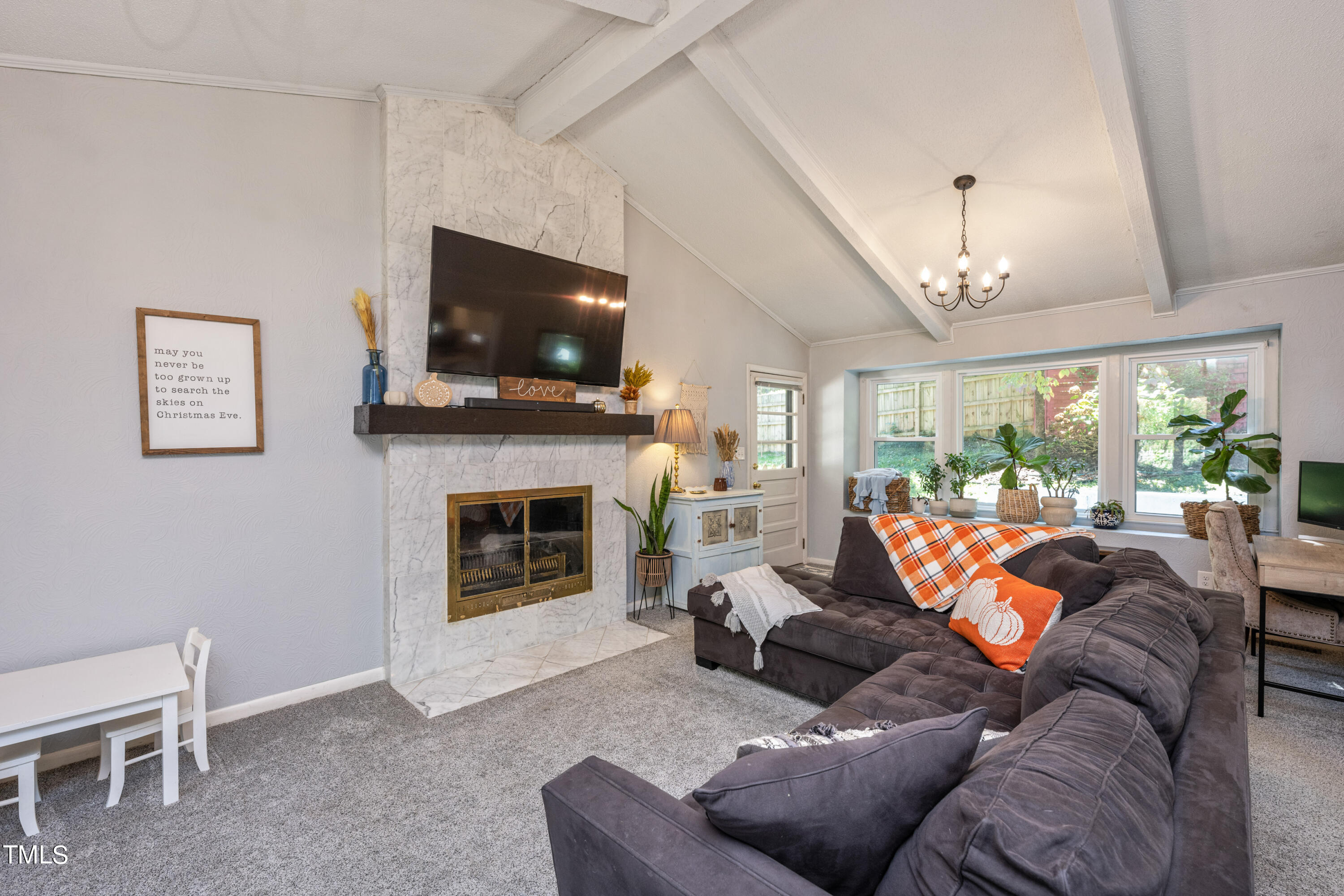 724 Hunting Ridge Road Raleigh, NC 27615 - Photo 7 of 24 a living room with furniture a flat screen tv and a fireplace