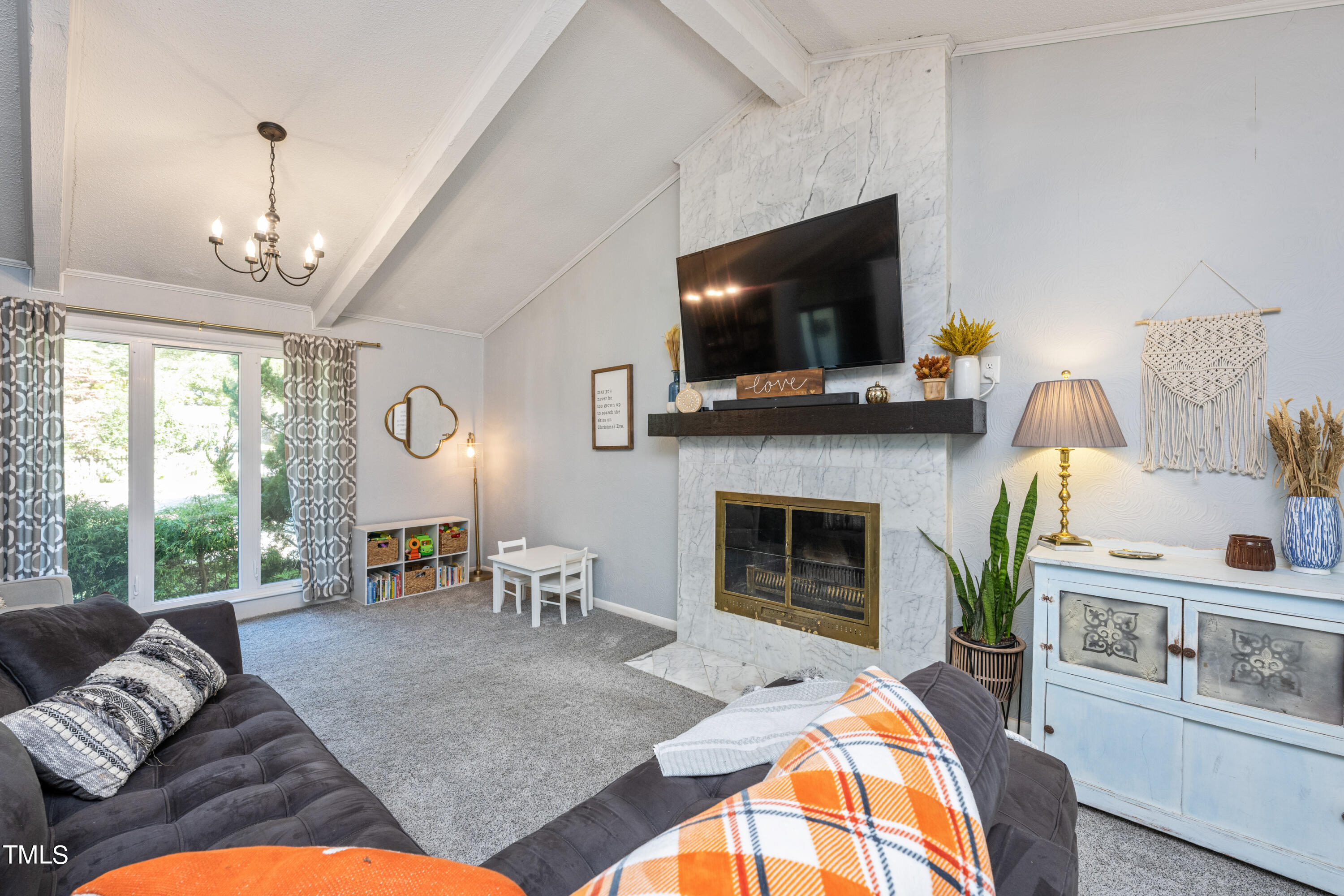 724 Hunting Ridge Road Raleigh, NC 27615 - Photo 8 of 24 a living room with furniture fireplace and flat screen tv