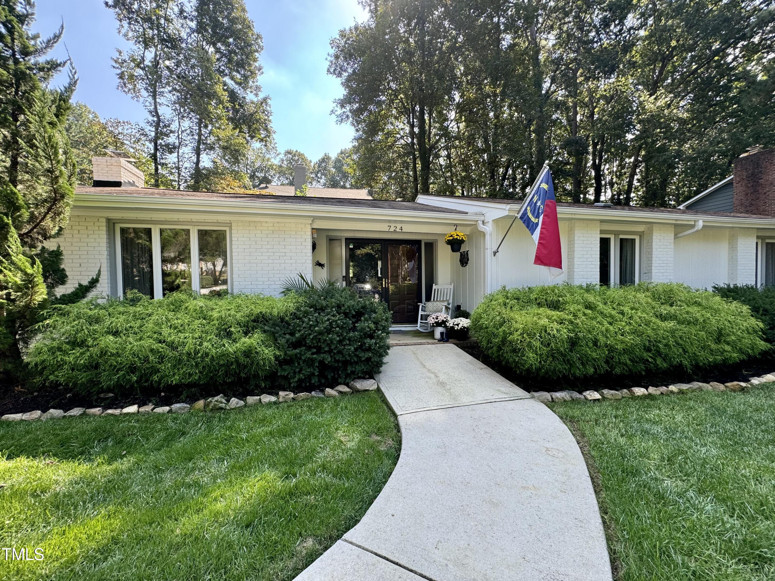 724 Hunting Ridge Road Raleigh, NC 27615 - Photo 9 of 24 a front view of a house with a yard and trees