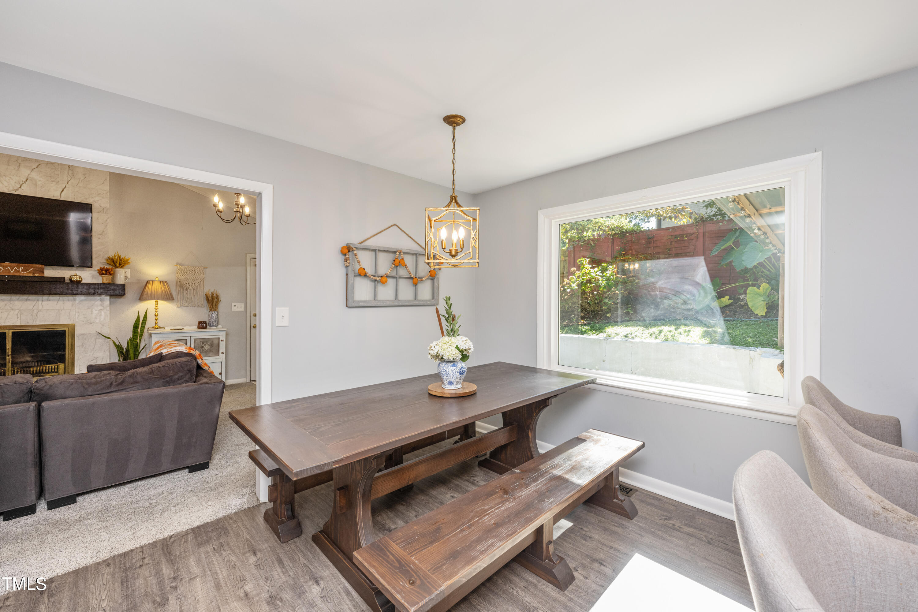 724 Hunting Ridge Road Raleigh, NC 27615 - Photo 10 of 24 a living room with furniture a flat screen tv and a fireplace