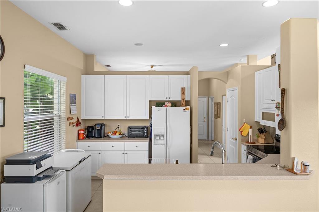 8830 Spring Mountain Way Fort Myers, FL 33908 - Photo 17 of 41 a kitchen with stainless steel appliances a refrigerator and a stove top oven