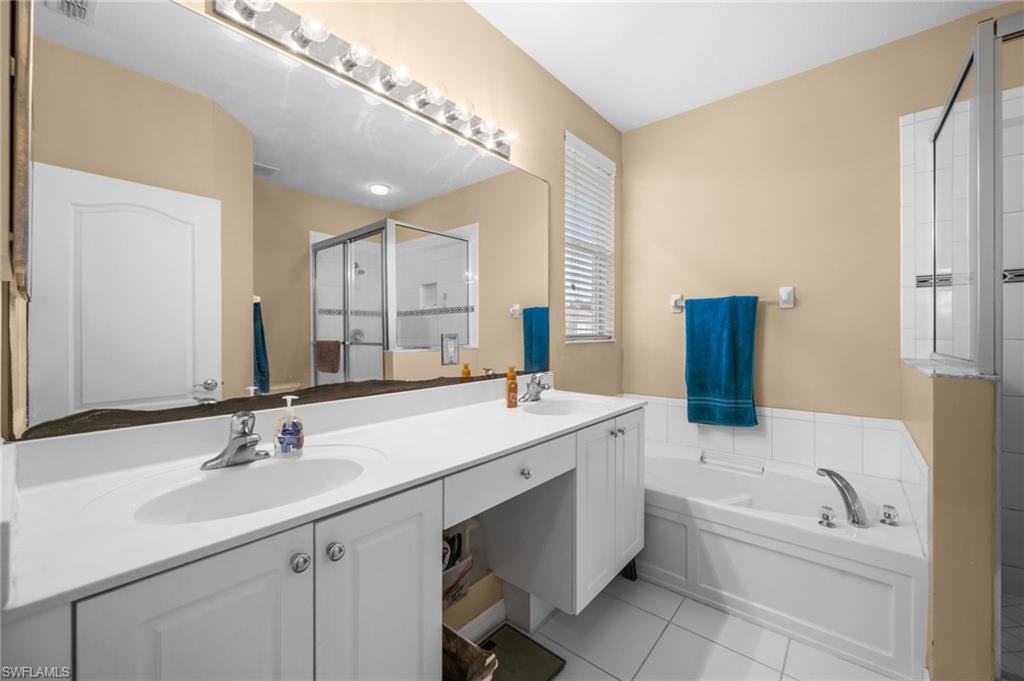 8830 Spring Mountain Way Fort Myers, FL 33908 - Photo 29 of 41 a bathroom with a sink double vanity granite tub and a mirror