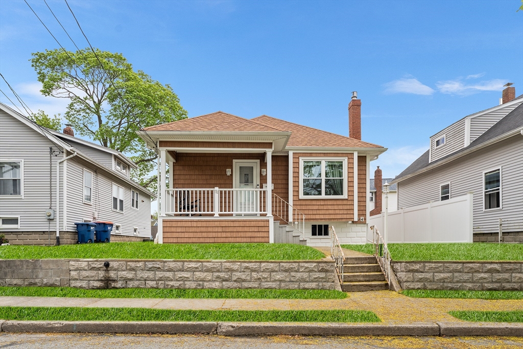 a front view of a house with a garden and plants