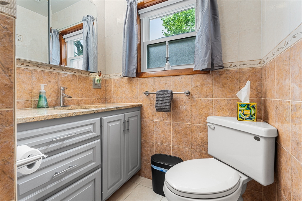 51 Cherry Street Fairhaven, MA 02719 - Photo 13 of 27 a white toilet sitting next to a bathroom sink