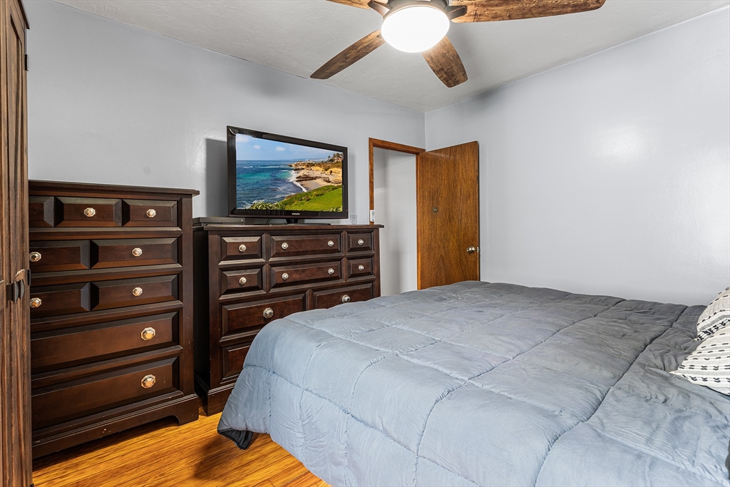 51 Cherry Street Fairhaven, MA 02719 - Photo 15 of 27 a bedroom with a bed and ceiling fan