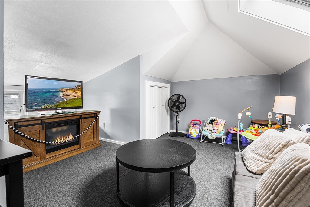 51 Cherry Street Fairhaven, MA 02719 - Photo 16 of 27 a bedroom with furniture and a fireplace