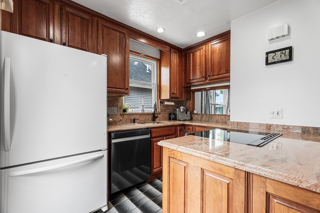 51 Cherry Street Fairhaven, MA 02719 - Photo 2 of 27 a kitchen with stainless steel appliances granite countertop a sink stove and refrigerator