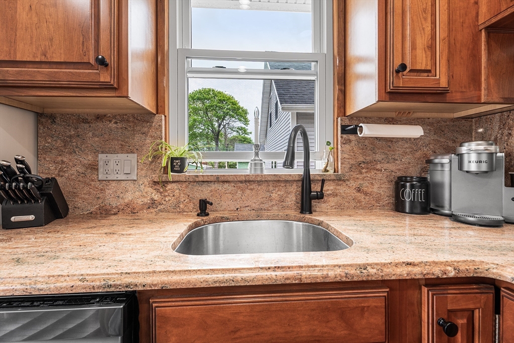 51 Cherry Street Fairhaven, MA 02719 - Photo 5 of 27 a kitchen with granite countertop a sink and a counter top space