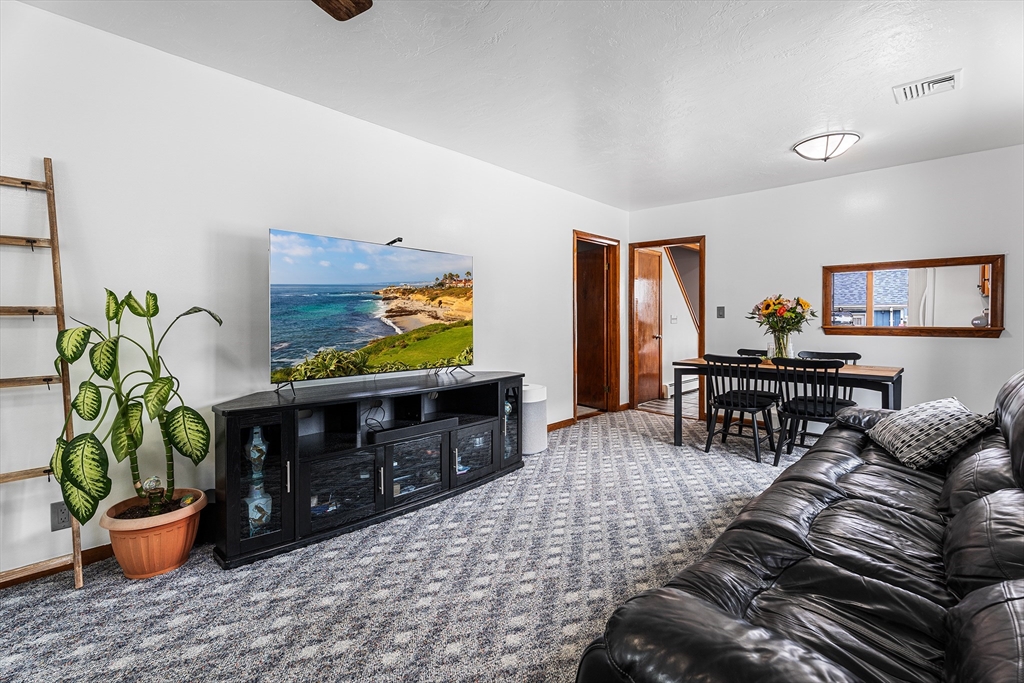 51 Cherry Street Fairhaven, MA 02719 - Photo 8 of 27 a living room with furniture and a potted plant