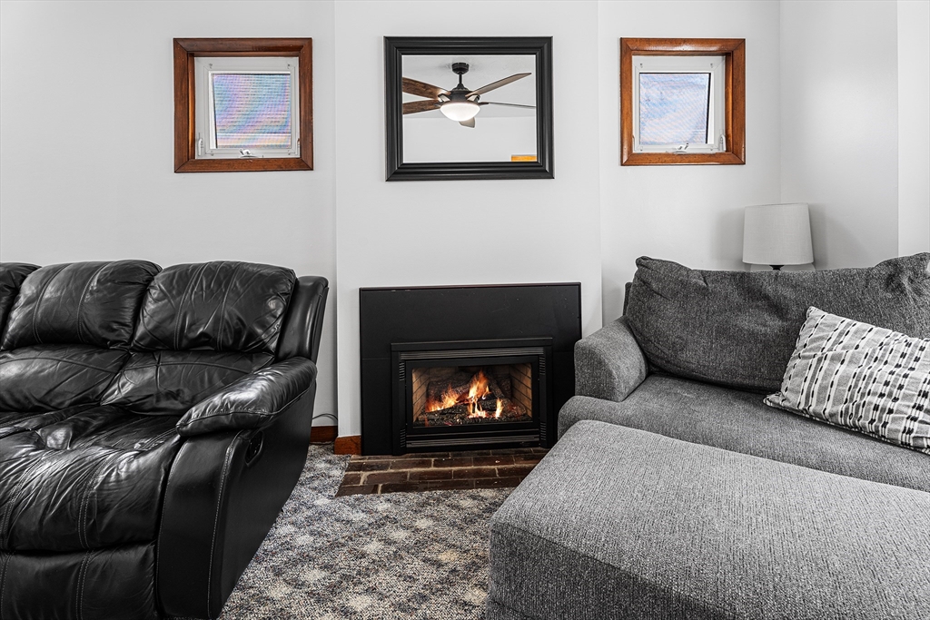51 Cherry Street Fairhaven, MA 02719 - Photo 9 of 27 a living room with furniture and a fireplace