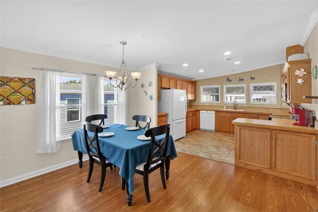 a kitchen with a sink refrigerator and cabinets
