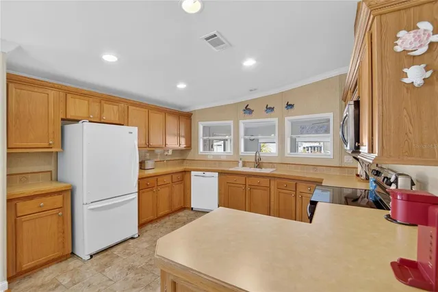 a kitchen with refrigerator cabinets dining table and chairs