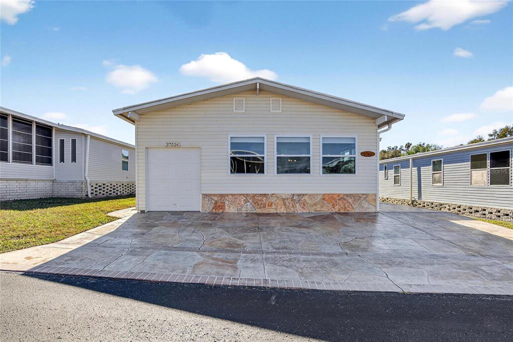 37526 Rio Lane Zephyrhills, FL 33541 - Photo 2 of 58 a view of a house with backyard and sitting area