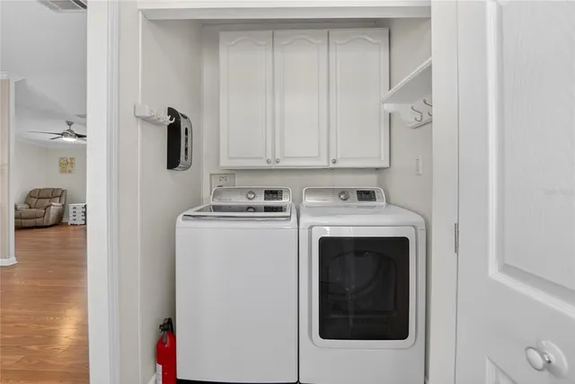 a bathroom with a sink a toilet a mirror a vanity a bathtub and shower