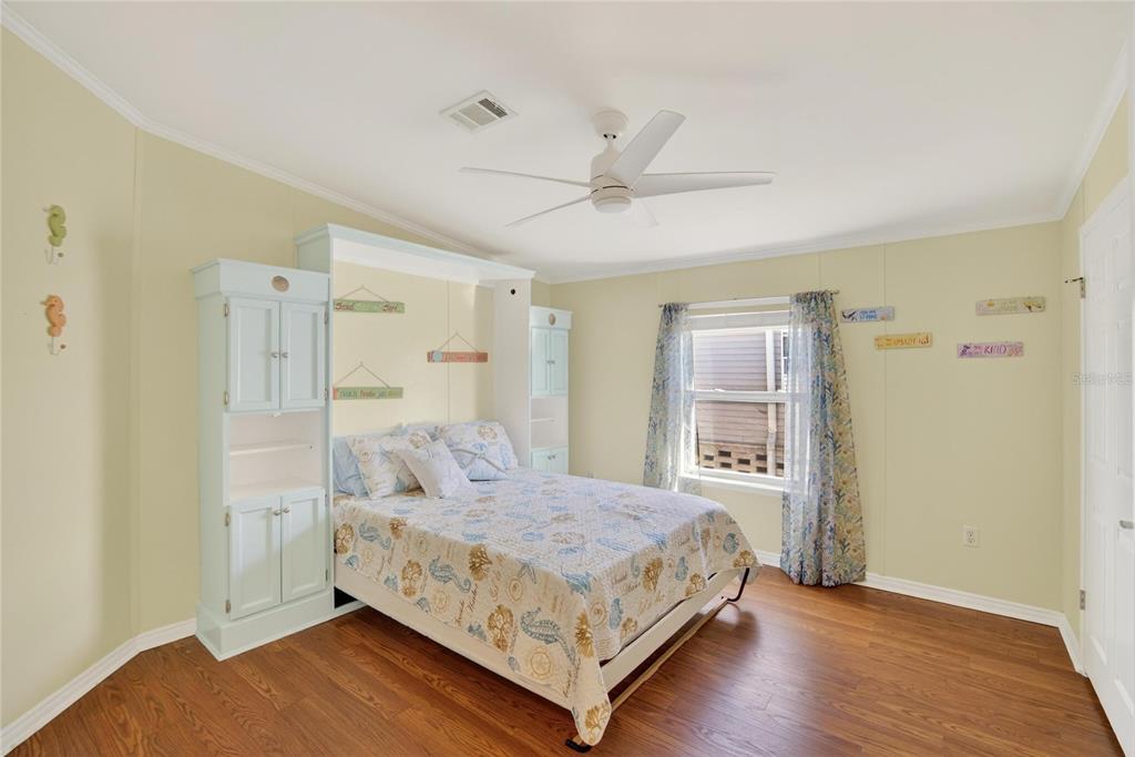 37526 Rio Lane Zephyrhills, FL 33541 - Photo 25 of 58 a spacious bedroom with a bed and a table