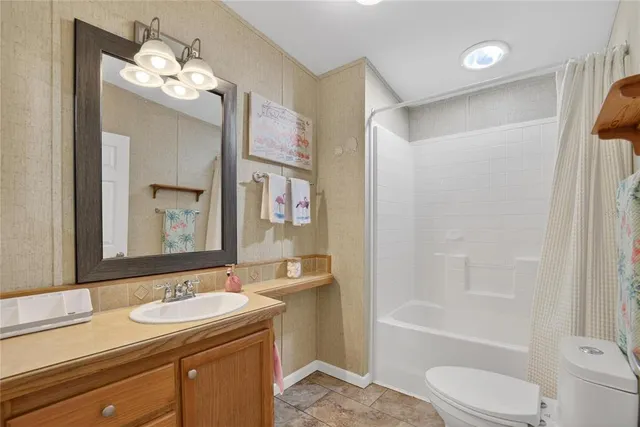 a bedroom with a bed and a chandelier fan