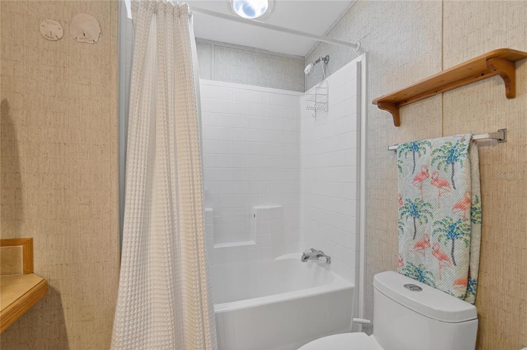 37526 Rio Lane Zephyrhills, FL 33541 - Photo 30 of 58 a bathroom with a shower curtain and a curtain
