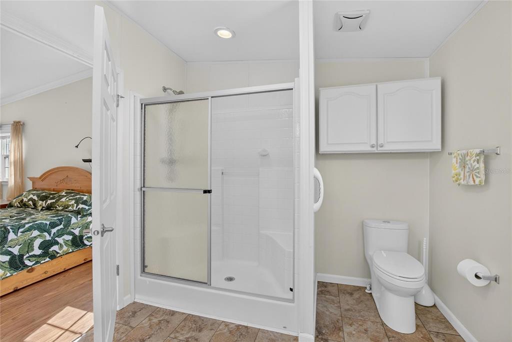 37526 Rio Lane Zephyrhills, FL 33541 - Photo 38 of 58 a bathroom with a toilet and a shower