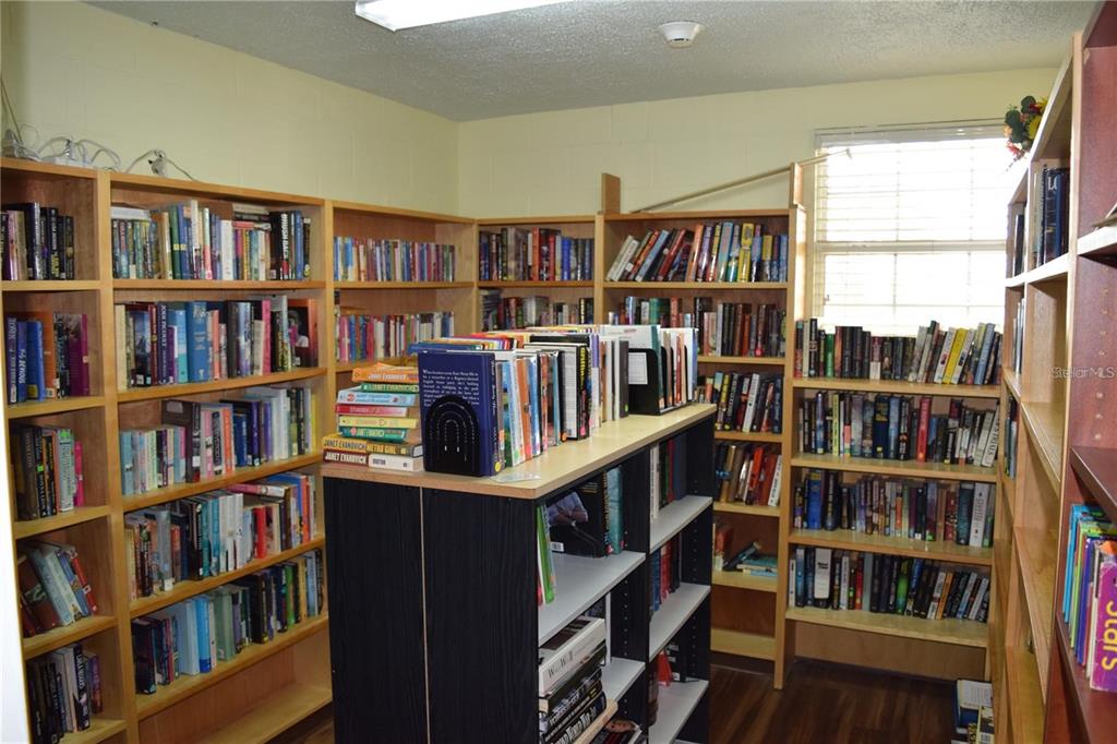 37526 Rio Lane Zephyrhills, FL 33541 - Photo 50 of 58 a view of a book shelf with lots of books