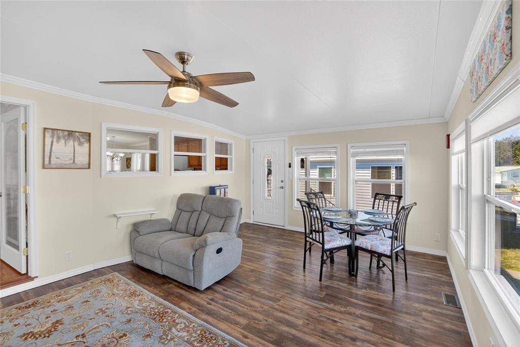 37526 Rio Lane Zephyrhills, FL 33541 - Photo 9 of 58 a living room with furniture and a wooden floor