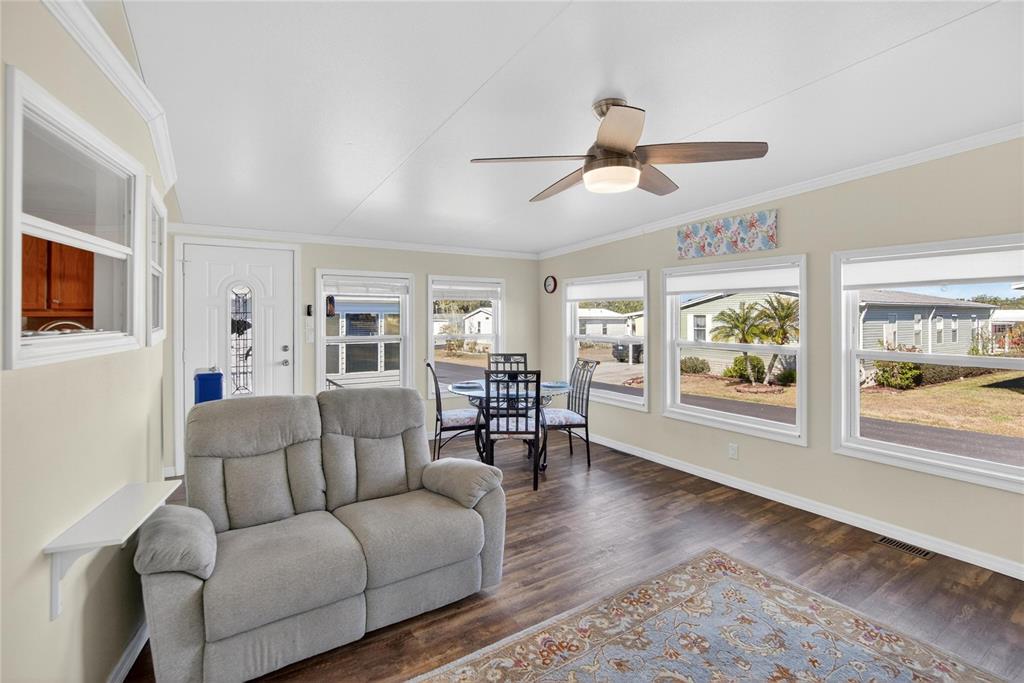 37526 Rio Lane Zephyrhills, FL 33541 - Photo 10 of 58 a living room with furniture wooden floor and a large window