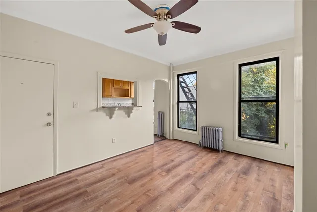 wooden floor in an empty room with a window