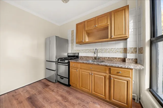 a kitchen with stainless steel appliances granite countertop a stove and a refrigerator